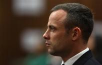South African Olympic and Paralympic athlete Oscar Pistorius sits in the dock during his murder trial in the North Gauteng High Court in Pretoria April 17, 2014. Pistorius is on trial for murdering his girlfriend Reeva Steenkamp at his suburban Pretoria home on Valentine's Day last year. REUTERS/Themba Hadebe/Pool (SOUTH AFRICA - Tags: SPORT CRIME LAW ATHLETICS HEADSHOT)