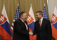 Slovakia's Prime Minister Peter Pellegrini, right, welcomes US Secretary of State Mike Pompeo during his visit to Bratislava, Slovakia, Tuesday, Feb. 12, 2019. Pompeo is in Slovakia on the second leg of a five-nation European tour that began in Hungary and will take him to Poland, Belgium and Iceland. (AP Photo/Petr David Josek)