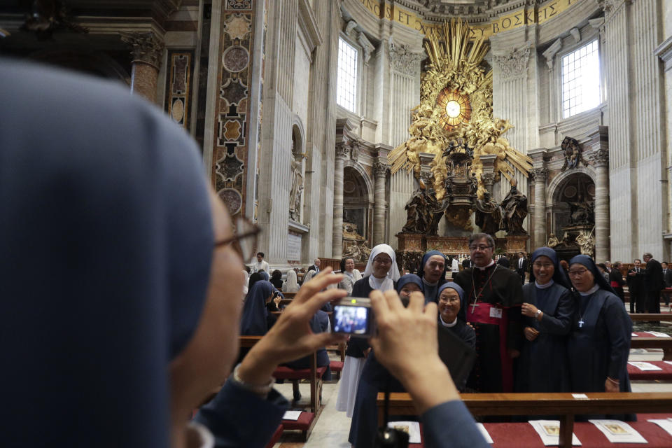 Nuns take a souvenirs picture inside the St. Peter's Basilica prior to the start of a mass for Peace celebrated by Vatican Secretary of State Pietro Parolin and attended by South Korean President Moon Jae-in and his wife Kim Jung-sook at the Vatican, Wednesday, Oct. 17, 2018. South Korea's president is in Italy for a series of meetings that will culminate with an audience with Pope Francis at which he's expected to extend an invitation from North Korean leader Kim Jong Un to visit. (AP Photo/Gregorio Borgia)