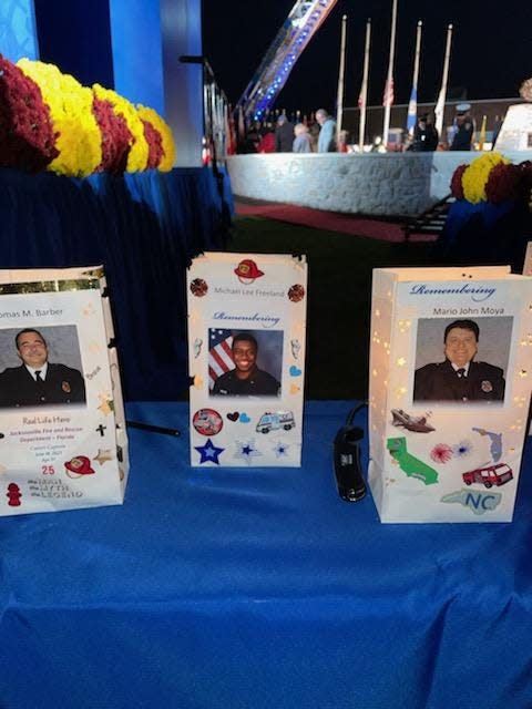 Luminaria bags with the faces of Jacksonville Fire and Rescue Department members (left to right) Lt. Mario Moya, Engineer Michael Freeland and Capt. Thomas Barber
 were part of the candlelight memorial during last weekend's National Fallen Firefighters Memorial in Maryland.