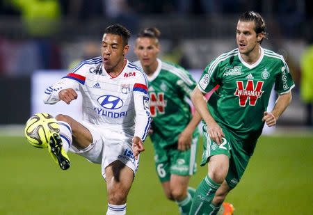 Olympique Lyon's Corentin Tolisso (L) challenges Saint-Etienne's Francois Clerc (R) during their French Ligue 1 soccer match at the Gerland stadium in Lyon April 19, 2015. REUTERS/Robert Pratta