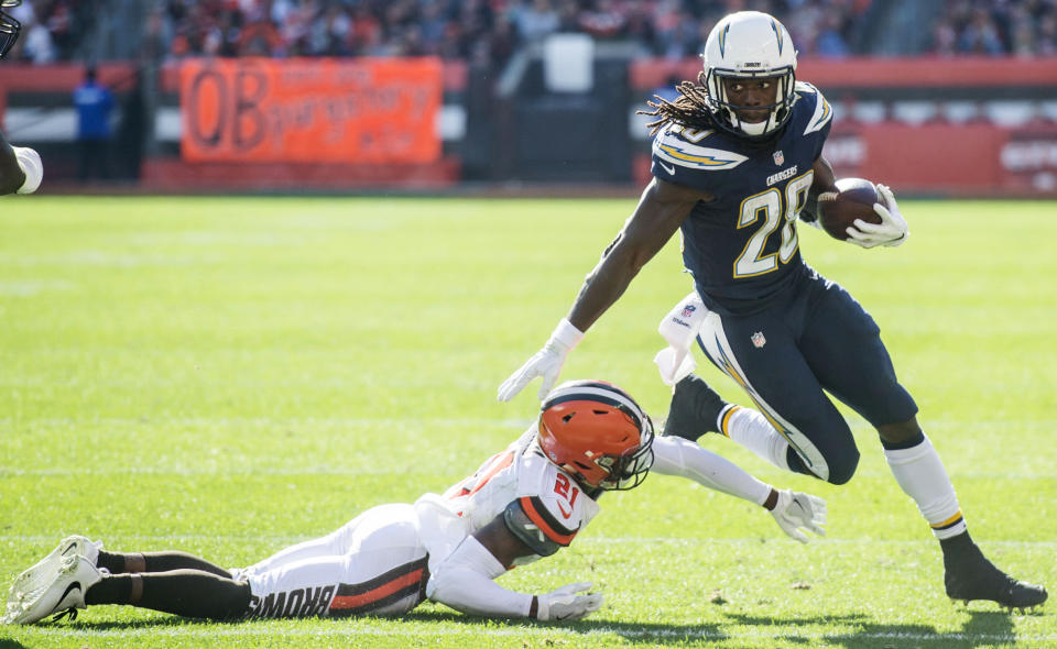 Oct 14, 2018; Cleveland, OH, USA; Los Angeles Chargers running back Melvin Gordon (28) eludes the tackle of Cleveland Browns cornerback Denzel Ward (21) during the second half at FirstEnergy Stadium. Mandatory Credit: Ken Blaze-USA TODAY Sports