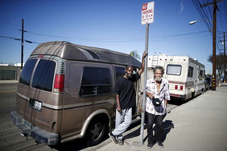 Bernard Leatherwood, 62, (L) and his friend Arthur Johnson, 72, pose for a portrait next to the motorhome in which they live on the streets of Los Angeles, California, United States, November 12, 2015. REUTERS/Lucy Nicholson