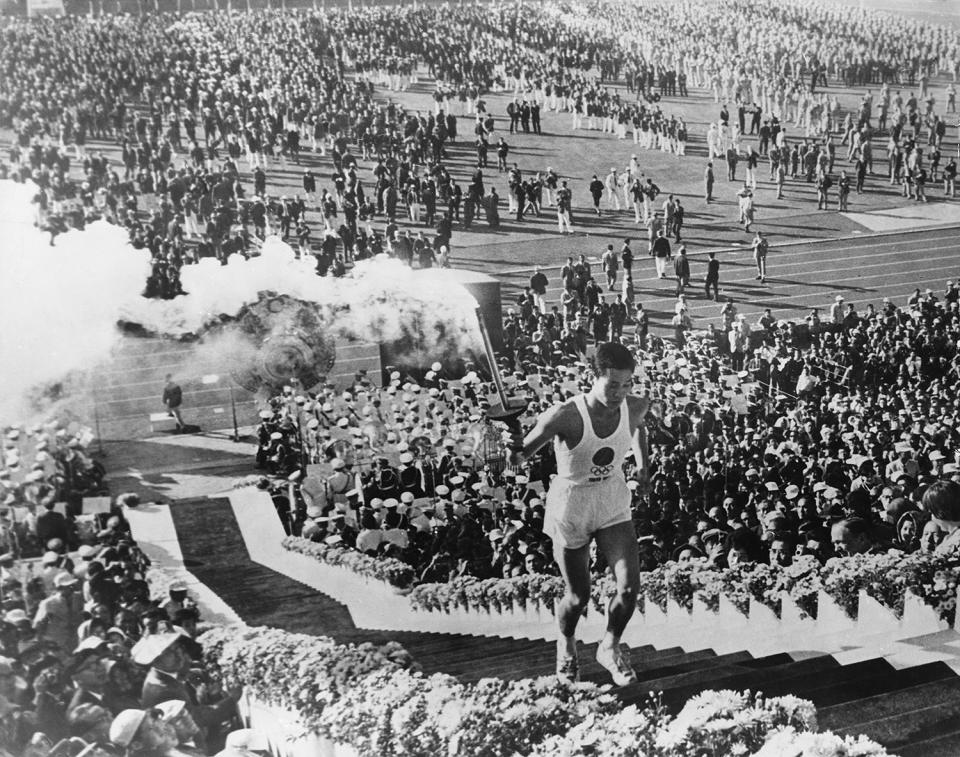 <p>Sakai runs up the steps to light the cauldron at the National Olympic Stadium on Oct. 10, 1964.</p>