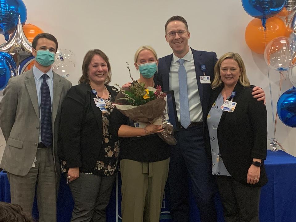 “Superhero in scrubs” Sarah Crowley, RN, of Kensington received the 2021 Nurse of the Year Award for her grace and positive attitude toward patients and her co-workers, which she brings to every unit of the hospital as a float nurse, in addition to the Emergency Department. From left, Dean M. Carucci, CEO of Portsmouth Regional Hospital; Michelle Dodd, Chief Nursing Officer; Crowley; Matthew Larkin, Chief Operating Officer; and Megan Gray, Associate Chief Nursing Officer.