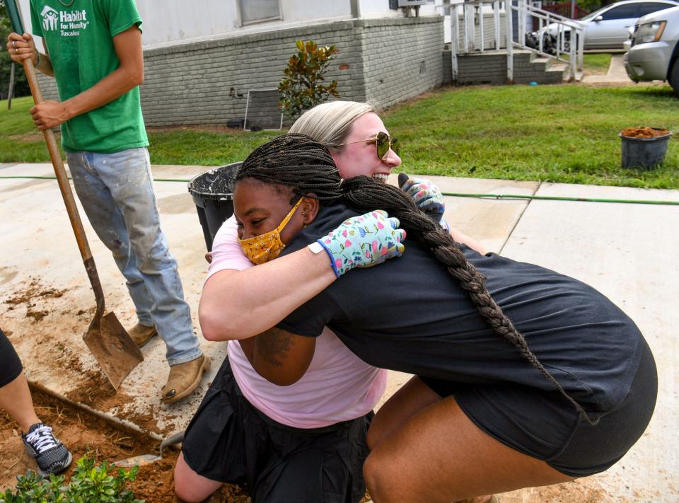 Aug 10, 2022; Tuscaloosa, AL, USA; Wives of University of Alabama's football coaching staff do the landscaping work for the Habitat for Humanity house that was funded by the Nick's Kids Foundation on Ash Street in Tuscaloosa, Wednesday, Aug. 10, 2022. Kristen Setas, daughter of Nick and Terry Saban, hugs homeowner Kanika Cotton. Gary Cosby Jr.-Tuscaloosa News