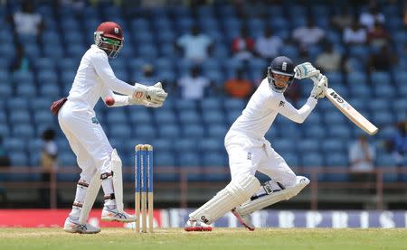 Cricket - West Indies v England - Second Test - National Cricket Ground, Grenada - 24/4/15 England's Joe Root in action as West Indies' Denesh Ramdin looks on Action Images via Reuters / Jason O'Brien