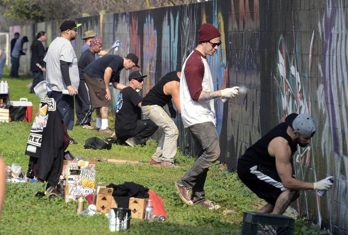 In this 2015 file photo, graffiti artists work on their sections of the wall at Calwa Park during the second annual Bizare Art Festival.