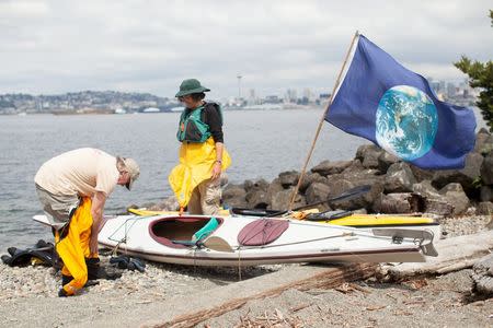 Martin Adams and Mira Leslie of Vashon Island, Washington, prepare to enter the Puget Sound during a flotilla protest against The Shell Oil Company's drilling rig Polar Pioneer in Seattle, Washington, May 14, 2015. REUTERS/Matt Mills McKnight