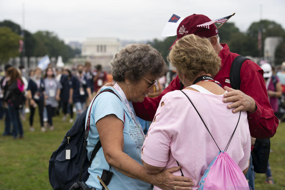 Followers of Franklin Graham stop to pray as they march from the Lincoln Memorial to Capitol Hill, during the Prayer March at the National Mall, in Washington, Saturday, Sept. 26, 2020. (AP Photo/Jose Luis Magana)