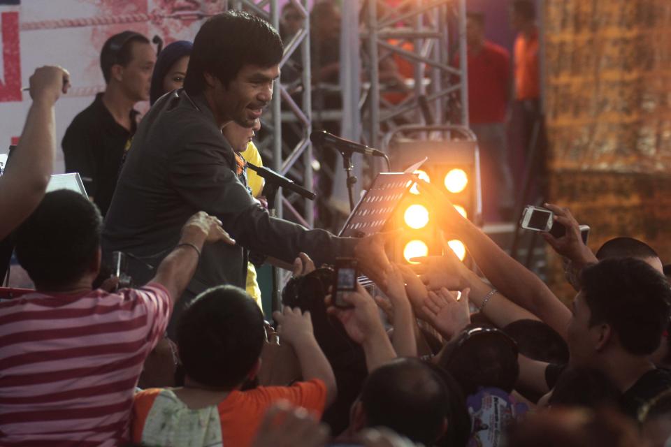 The crowd celebrates the homecoming of Manny Pacquiao at the Music Hall of the Mall of Asia in Pasay city, south of Manila, on 12 December 2012. (George Calvelo/NPPA Images)