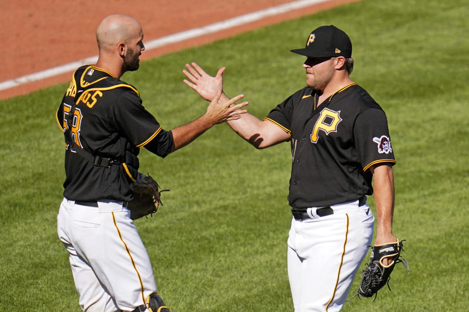 Pittsburgh Pirates relief pitcher David Bednar, right, celebrates with catcher Jacob Stallings after striking out the side in the ninth inning to preserve a win over the Detroit Tigers in a baseball game in Pittsburgh, Monday, Sept. 6, 2021. (AP Photo/Gene J. Puskar)