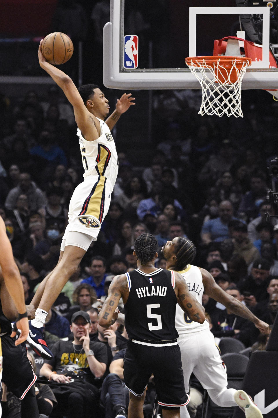 New Orleans Pelicans guard Trey Murphy III, left, dunks as Los Angeles Clippers guard Bones Hyland, center, and forward Naji Marshall watch during the first half of an NBA basketball game Saturday, March 25, 2023, in Los Angeles. (AP Photo/Mark J. Terrill)