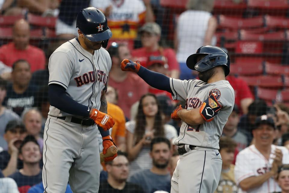 Houston Astros' Jose Altuve, right, celebrates his solo home run with teammate Carlos Correa, left, during the third inning of a baseball game against the Boston Red Sox, Wednesday, June 9, 2021, in Boston. (AP Photo/Michael Dwyer)