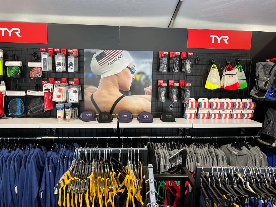 The competitive swimwear brand TYR moved quickly after signing Claire Curzan to an NIL deal in February. By April, she was featured with this spread of products in a pop-up shop at the Greensboro Aquatic Center, where she competed in Team USA's International Team Trials for the 2022 FINA World Championships.