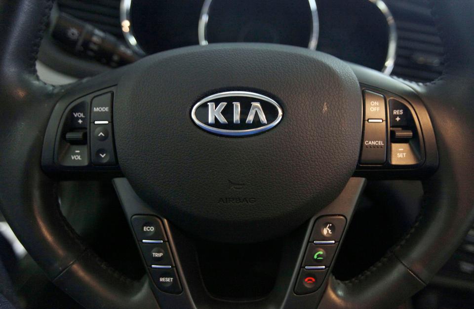 The Kia logo brands a steering wheel inside of a Kia car dealership in Elmhurst, Ill., Oct. 5, 2012.