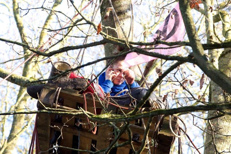 Protester keeps watch from treehouse at camp protecting stretch of woodland and wetland in Colne Valley Regional Park