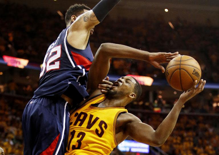 Mike Scott (L) of the Atlanta Hawks defends against Tristan Thompson of the Cleveland Cavaliers in overtime during Game Three of the Eastern Conference Finals at Quicken Loans Arena on May 24, 2015