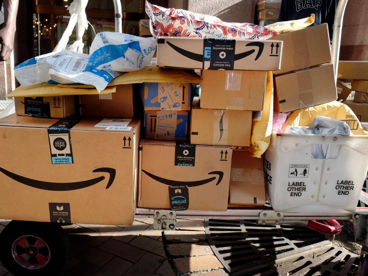 FILE - In this Oct. 10, 2018, file photo, Amazon Prime boxes are loaded on a cart for delivery in New York. Amazon said Tuesday, June 23, 2020, that its carbon footprint rose 15% last year, even as it launched initiatives to reduce its harm on the environment. (AP Photo/Mark Lennihan, File)