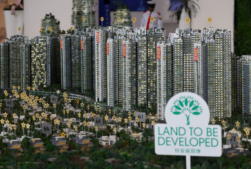 FILE PHOTO: A model shows sold-out signs on residential apartment blocks at the showroom in Country Garden's Forest City development in Johor Bahru