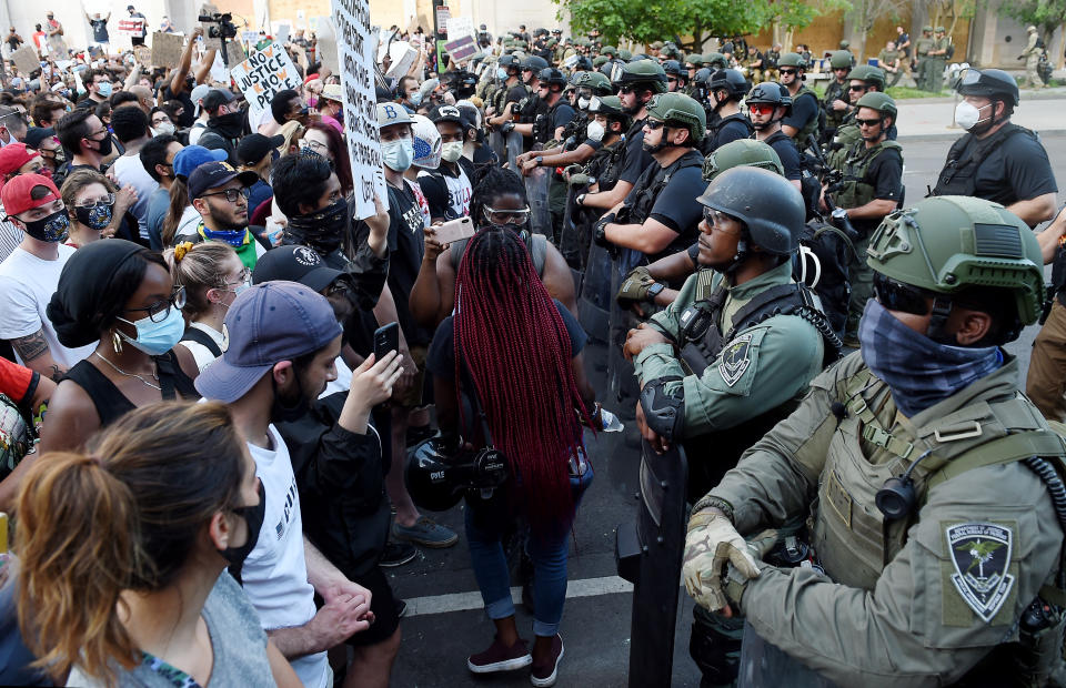 Police face and demonstrators face off near the White House during a protest over the death of George Floyd,in Washington, DC, on June 3, 2020. - Former Minneapolis police officer Derek Chauvin, who kneeled on the neck of George Floyd who later died, will now be charged with second-degree murder, and his three colleagues will face charges of aiding and abetting second-degree murder, court documents revealed on June 3. (Photo by Olivier DOULIERY / AFP) (Photo by OLIVIER DOULIERY/AFP via Getty Images)