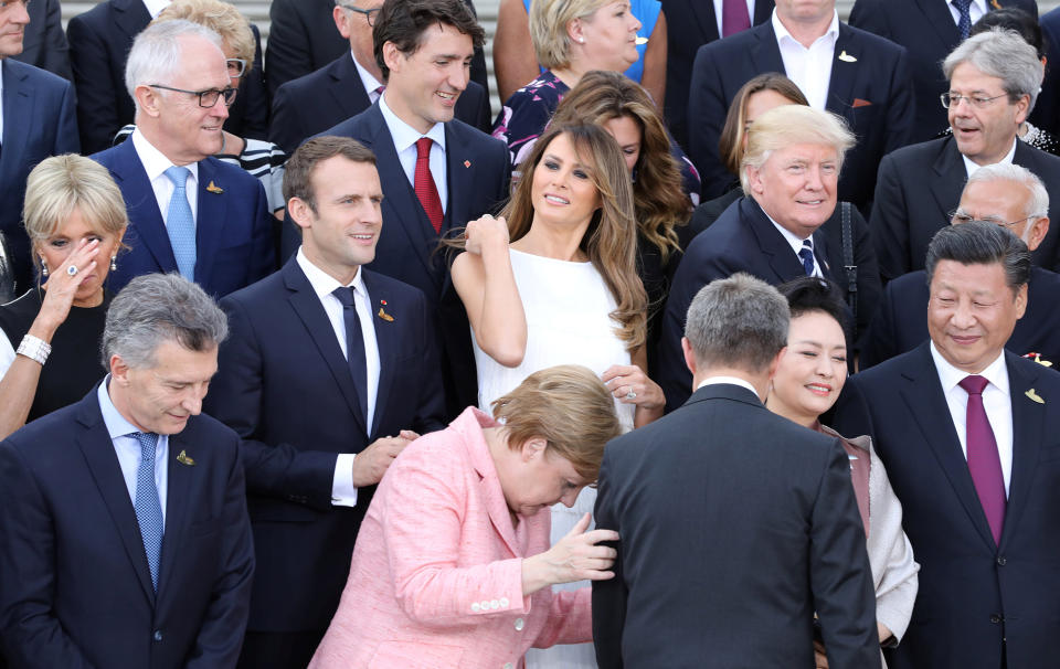 <p>(2nd row L-R) Wife of French President Brigitte Trogneux, French President Emmanuel Macron, First Lady Melania Trump, President Donald Trump as German Chancellor Angela Merkel is seen in front during a family photo prior to a concert at the Elbphilharmonie concert hall during the G20 Summit in Hamburg, Germany, on July 7, 2017. (Photo: Ludovic Marin,Pool/Reuters) </p>