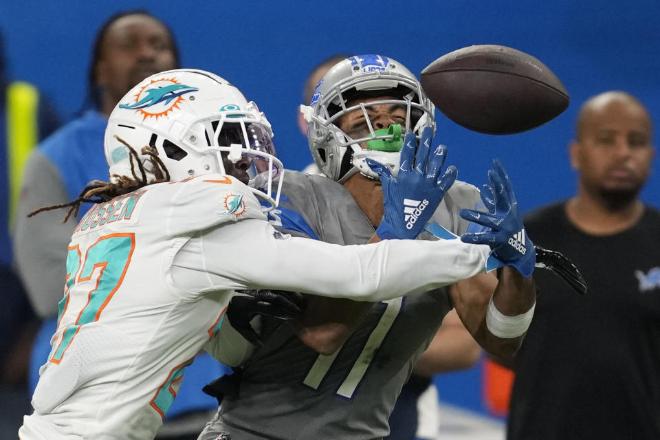 Miami Dolphins cornerback Keion Crossen deflects the ball away from Detroit Lions wide receiver Kalif Raymond (11) during the second half of an NFL football game, Sunday, Oct. 30, 2022, in Detroit. (AP Photo/Paul Sancya)