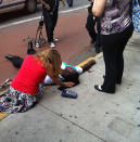 WARNING: GRAPHIC CONTENT. A man lies wounded on the ground after a gunman opened fire outside of New York's Empire State Building. Twitter photo courtesy of Minutuono (@minutounocom)