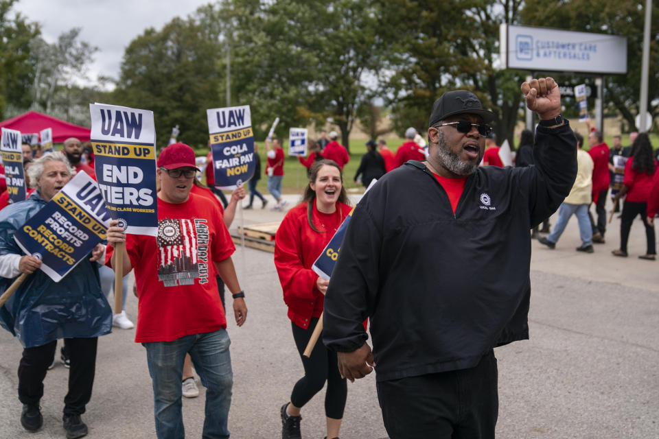 United Auto Workers march on the picket line outside the Willow Run Redistribution Center, UAW Local 174, Tuesday, Sept. 26, 2023, in Van Buren Township, Mich. (AP Photo/Evan Vucci)