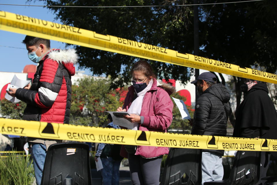 People line up to be tested for COVID-19, in the Benito Juarez borough of Mexico City, Saturday, Jan. 15, 2022. (AP Photo/Ginnette Riquelme)