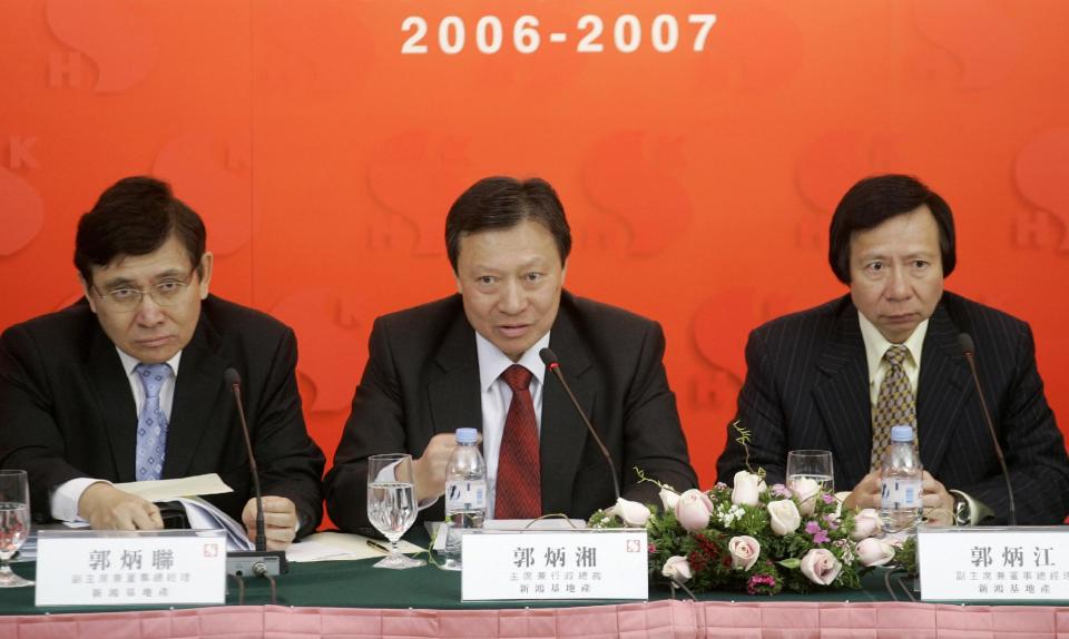 FILE - In this March 7, 2007 file photo, Walter Kwok, center, chairman and chief executive, Raymond Kwok, left, and Thomas Kwok, right, both vice chairman and managing director, of Sun Hung Kai Properties attend a press conference to announce their company's interim results in Hong Kong. Walter Kwok was arrested Thursday, May 3, 2012 in a high profile anti-corruption probe that has already targeted his billionaire brothers and a top official. (AP Photo/Vincent Yu, File)