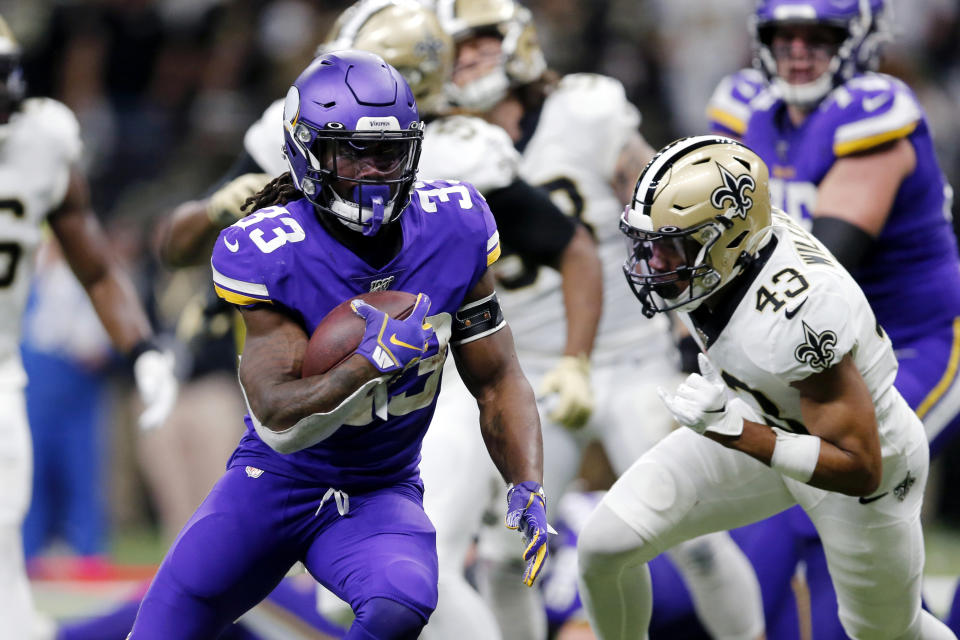 FILE - In this Jan. 5, 2020, file photo, Minnesota Vikings running back Dalvin Cook (33) carries for a touchdown in front of New Orleans Saints free safety Marcus Williams (43) during the first half of an NFL wild-card playoff football game in New Orleans. The Vikings are banking heavily on Cook this season, and he is counting on a new contract. (AP Photo/Brett Duke, File)