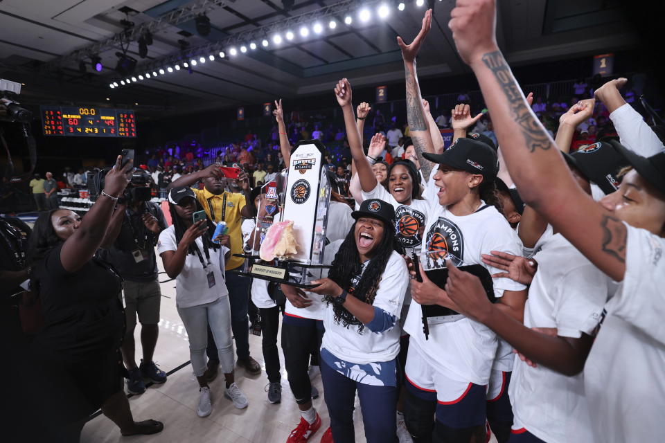 Mississippi head coach Yolett McPhee-McCuin holds the trophy after defeating Michigan in an NCAA college basketball game in the Battle 4 Atlantis at Paradise Island, Bahamas, Monday, Nov. 20, 2023. (Tim Aylen/Bahamas Visual Services via AP)