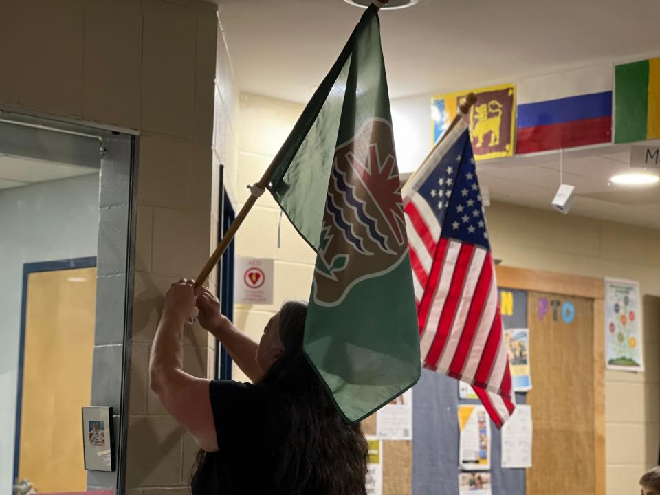 Abenaki Nation of Missisquoi Chief Brenda Gagne raises her tribe's flag at Gertrude Chamberlin School in South Burlington on Nov. 14, 2023.