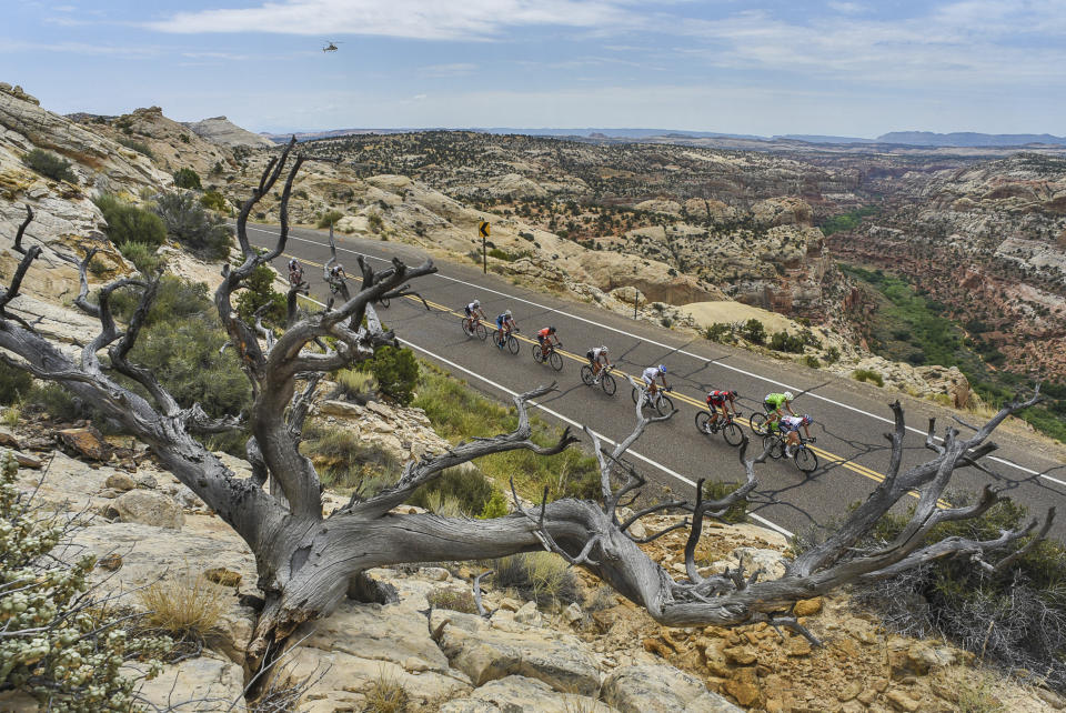 FILE - In this Aug. 2, 2016, file photo, cyclists race along the scenic Byway 12 above the Grand Staircase-Escalante National Monument during the Tour Of Utah bike race. The U.S. government implemented final management plans Thursday, Feb. 6, 2020, for two national monuments in Utah that President Donald Trump downsized. The plans ensure lands previously off-limits to energy development will be open to mining and drilling despite pending lawsuits by conservation, tribal and paleontology groups challenging the constitutionality of the president's action. (Francisco Kjolseth/The Salt Lake Tribune via AP, File)
