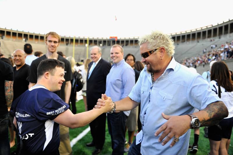 ALLSTON, MA - MAY 29:  Buddy Chris Harrington (L) and Chef Guy Fieri attend the Tom Brady Football Challenge for The Best Buddies Challenge: Hyannis Port 2015 at Harvard Field on May 29, 2015 in Allston, Massachusetts.