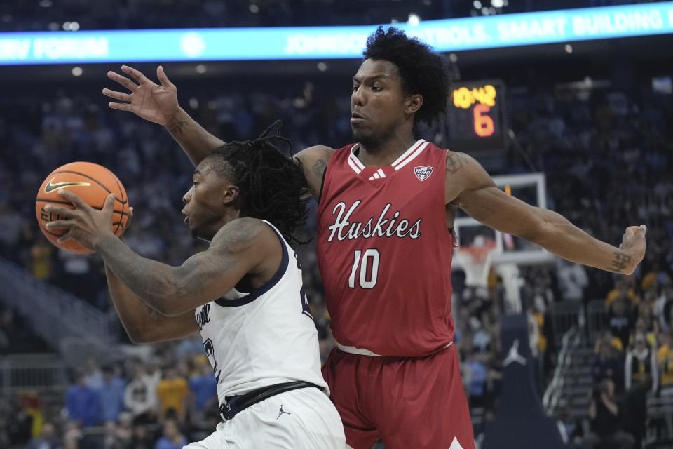 Marquette's Chase Ross drives past Northern Illinois's Zion Russell during the first half of an NCAA college basketball game Monday, Nov. 6, 2023, in Milwaukee. (AP Photo/Morry Gash)