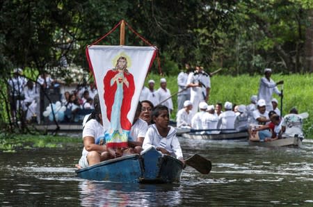 FILE PHOTO: Roman Catholic pilgrims travel as they accompany the statue of Our Lady of Conception during an annual river procession and pilgrimage along the Caraparu River in Santa Izabel do Para