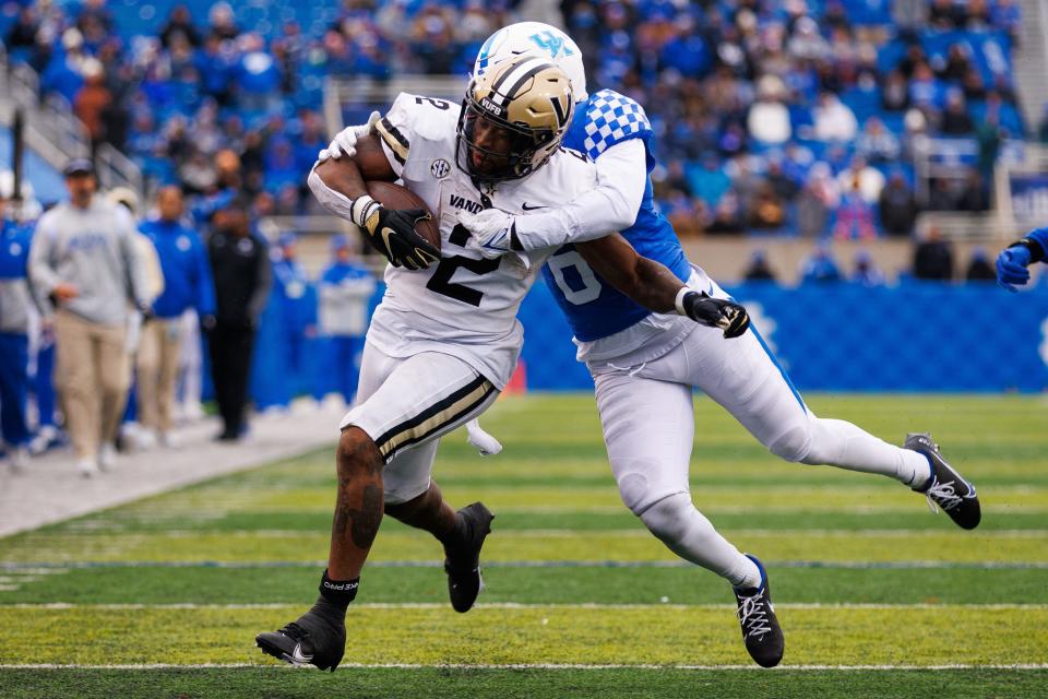 Nov 12, 2022; Lexington, Kentucky, USA; Vanderbilt Commodores running back Ray Davis (2) carries the ball against Kentucky Wildcats defensive back Tyrell Ajian (6) during the third quarter at Kroger Field. Mandatory Credit: Jordan Prather-USA TODAY Sports