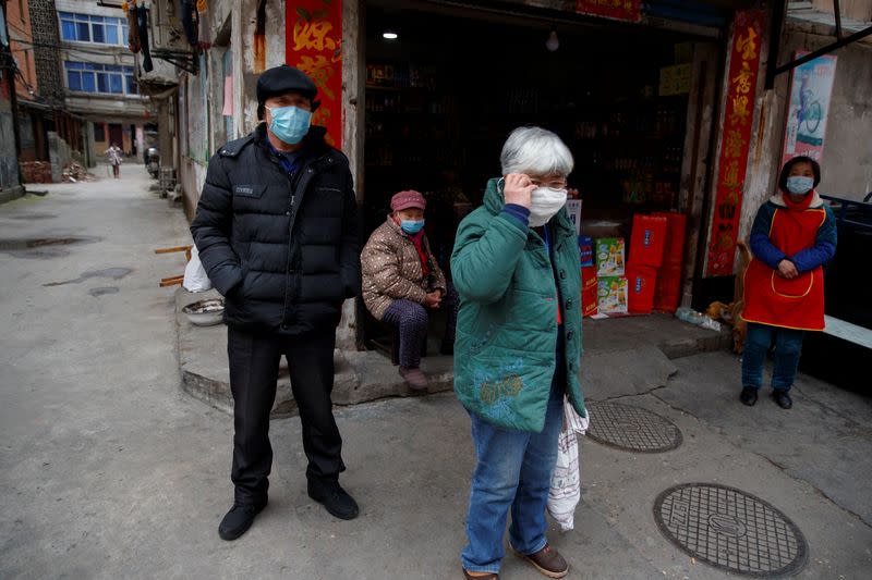 People wear protective masks in an old neighbourhood of Jiujiang