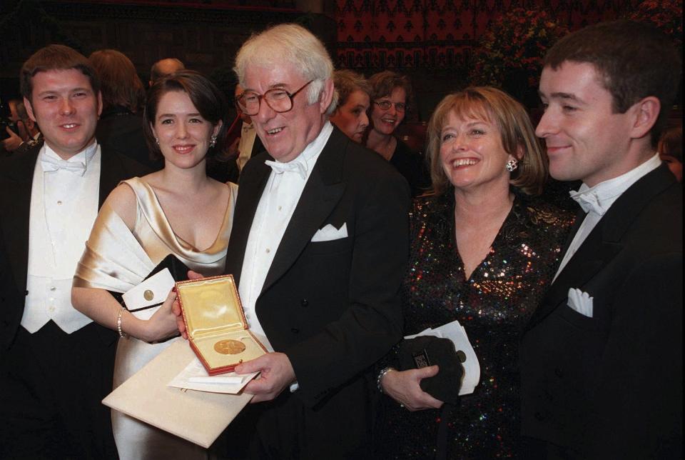 FILE - Irish poet Seamus Heaney, center, displays his Nobel literature prize medal, surrounded by his family, after receiving it from the Swedish King Carl XVI Gustaf at the Concert Hall in Stockholm, Sweden on Dec. 10, 1995. Heaney's family are from left: his son Michael, daughter Catherine, his wife Marie and son Christopher. Presidents have long made a point of citing a favorite writer, and for President Joe Biden that often has been Heaney, renowned for what Nobel judges in 1995 called “works of lyrical beauty and ethical depth." (AP Photo/Eric Roxfelt, File)
