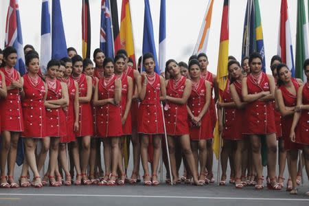 Pit girls rehearse on the eve of the Indian F1 Grand Prix at the Buddh International Circuit in Greater Noida, on the outskirts of New Delhi, October 26, 2013. REUTERS/Anindito Mukherjee