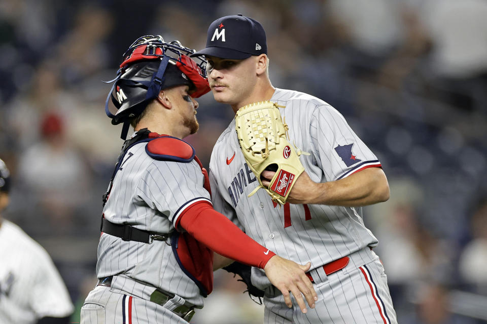 Minnesota Twins' Cole Sands, right, and Christian Vazquez celebrate the team's win over the New York Yankees in a baseball game Thursday, April 13, 2023, in New York. (AP Photo/Adam Hunger)