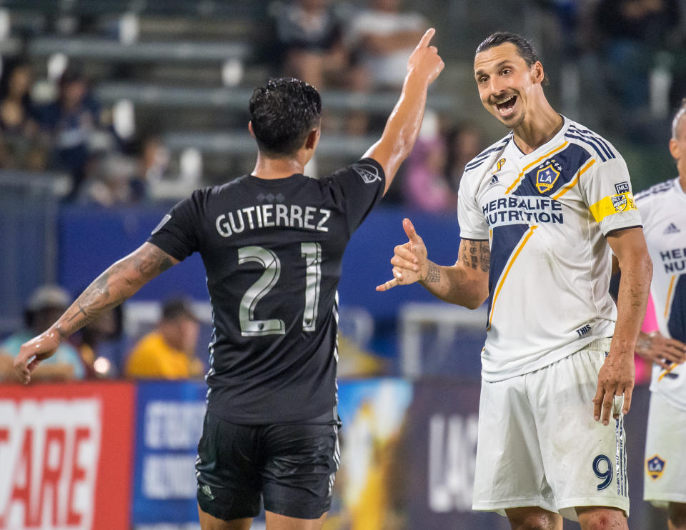 CARSON, CA -SEPTEMBER 15: Zlatan Ibrahimovic #9 of Los Angeles Galaxy talks to Felipe Gutierrez #21 of Sporting Kansas City during the Los Angeles Galaxy's MLS match against Sporting KC at the Dignity Health Sports Park on September 15, 2019 in Carson, California.  Los Angeles Galaxy won the match 7-2 (Photo by Shaun Clark/Getty Images)