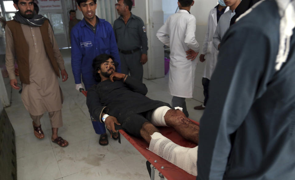 Afghans carry a wounded man into a hospital after a suicide attack in northern Parwan province, Afghanistan, Tuesday, Sept. 17, 2019. The Taliban suicide bomber on a motorcycle targeted presidential guards who were protecting President Ashraf Ghani at a campaign rally in northern Afghanistan on Tuesday, killing over 20 people and wounding over 30. Ghani was present at the venue but was unharmed, according to his campaign chief. (AP Photo/Rahmat Gul)