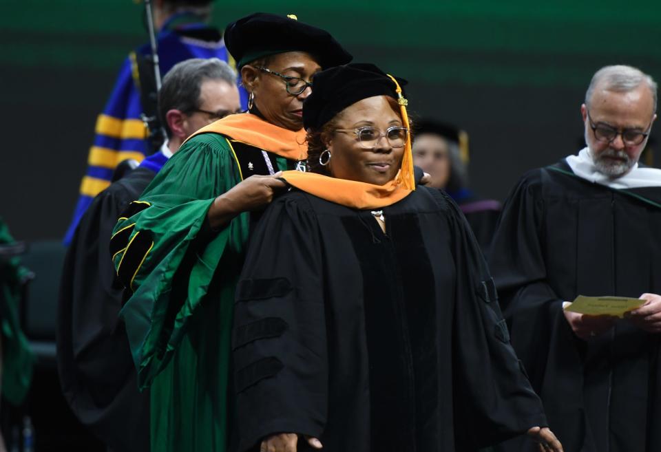 MSU PhD. recipient Robin Smith is hooded Friday, Dec. 16, 2022, during the 2022 Fall Commencement ceremony at the Breslin in East Lansing. Smith received her doctorate in nursing.