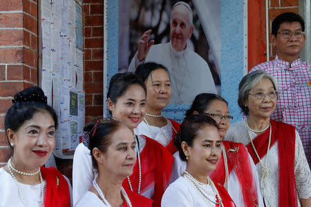 Catholic women pose for a picture next to a poster of Pope Francis, ahead of his visit to Yangon, Myanmar November 26, 2017. REUTERS/Jorge Silva