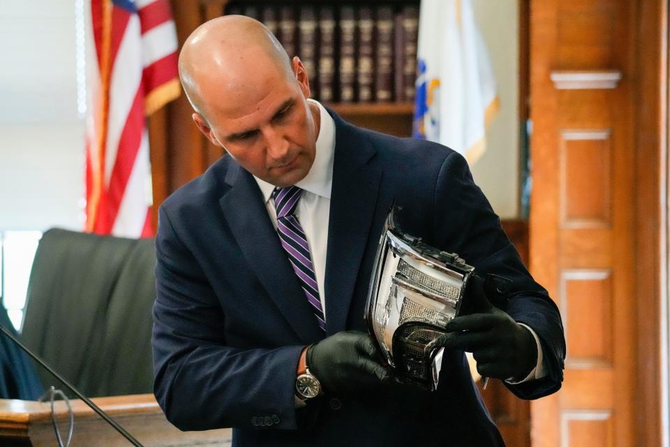 Massachusetts State Police Trooper Michael Proctor shows the jury a broken tail light while testifying, Monday, June 10, 2024, at Norfolk Superior Court, in Dedham, Mass., during the trial for Karen Read. Read is accused of killing her boyfriend, Boston police Officer John O'Keefe, in 2022. (Kayla Bartkowski/The Boston Globe via AP, Pool)
