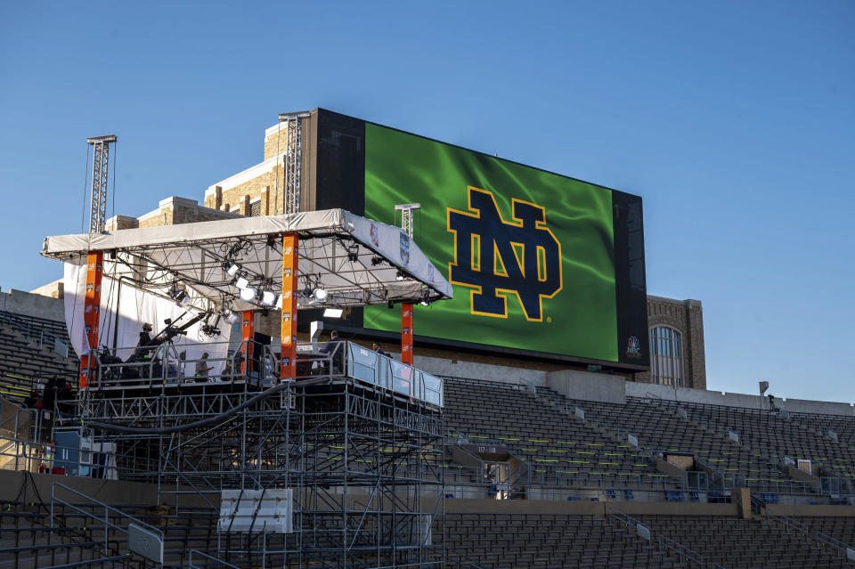 ESPN College Gameday hosts Davis, David Pollack and Kirk Herbstreit prepare for their live broadcast from Notre Dame Stadium before the NCAA college football game between the Notre Dame and the Clemson in South Bend, Ind. (Matt Cashore/Pool Photo via AP)