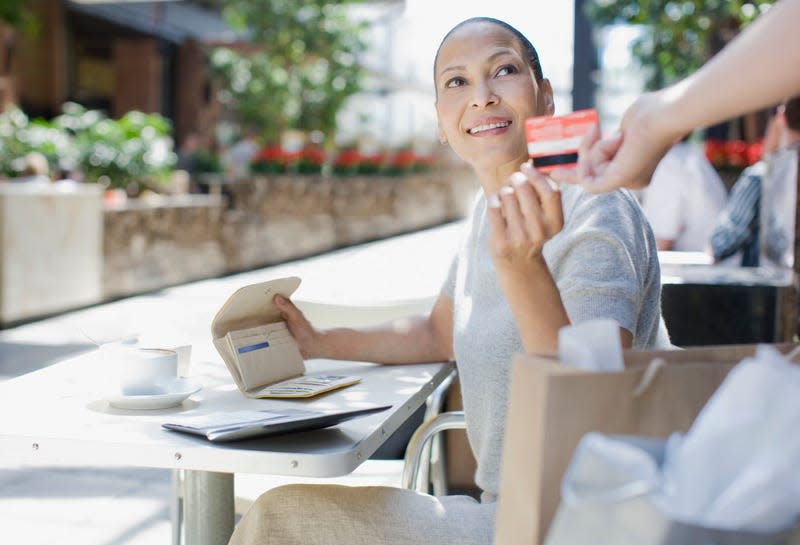 Black woman reaching into wallet